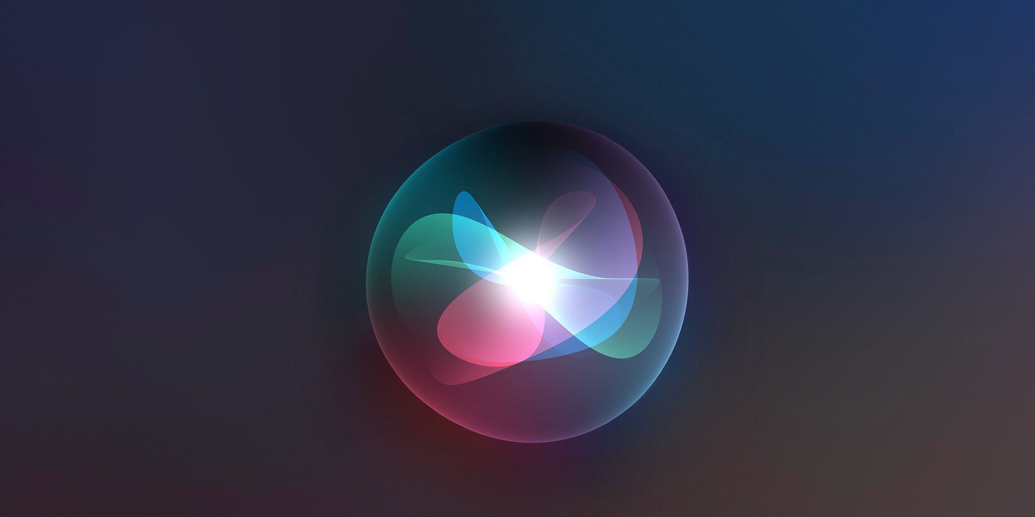 A glowing, multicolored abstract light pattern inside a transparent sphere against a dark background.