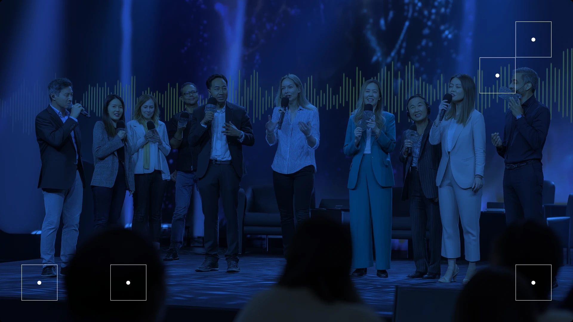 Group of people speaking on stage at a conference or event.