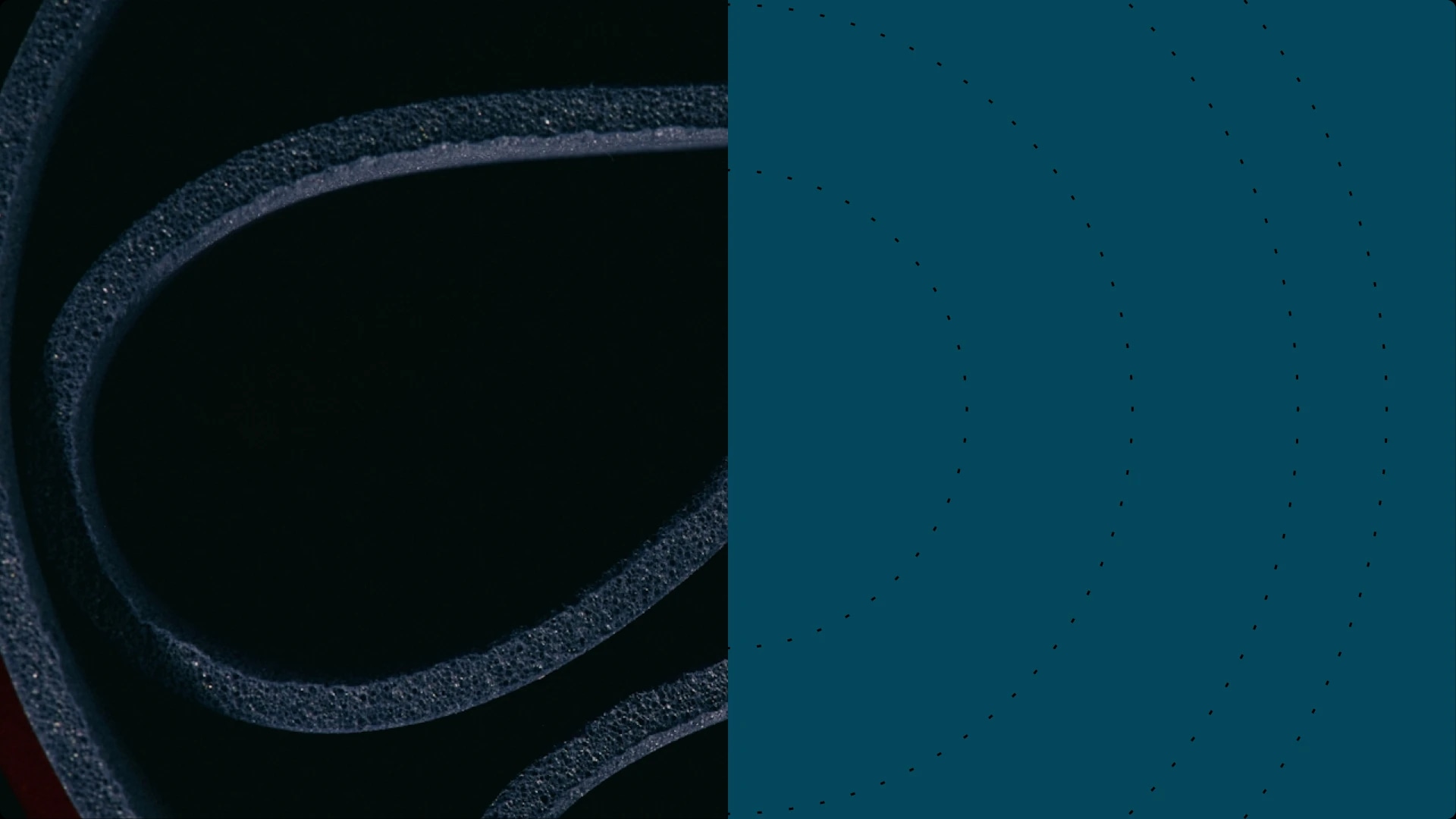 Close-up of a black foam yoga mat rolled up.