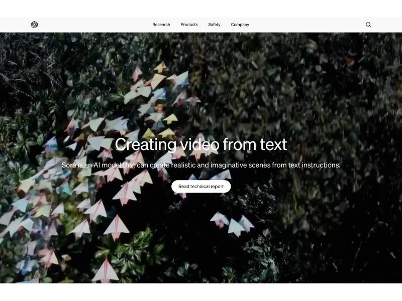 A website homepage with a background image of colorful paper umbrellas hanging among green foliage, featuring a headline about creating videos from text and a call-to-action button.