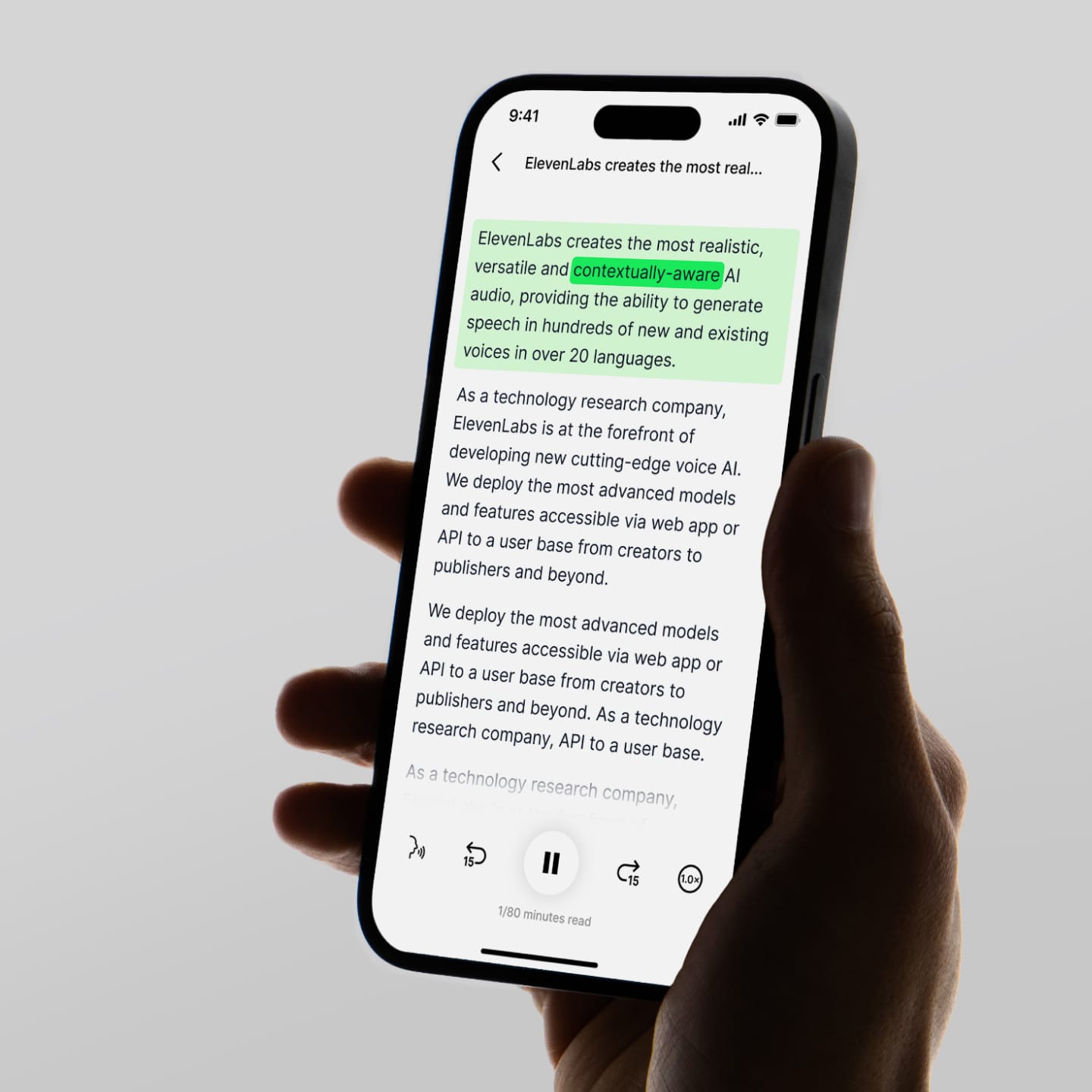 Alt text: A hand holding a smartphone displaying a text-to-speech app with highlighted text and playback controls.
